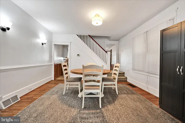 a dining room with furniture and entryway