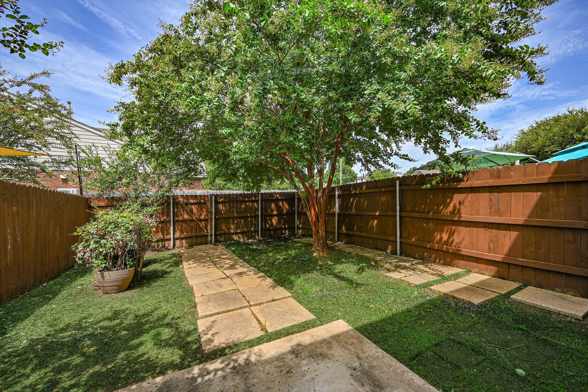 93 Verde Ranch Loop Leander, TX 78641 - Photo 20 of 20 a view of backyard with table and chairs potted plants and large tree