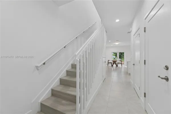 a view of entryway and hall with wooden floor