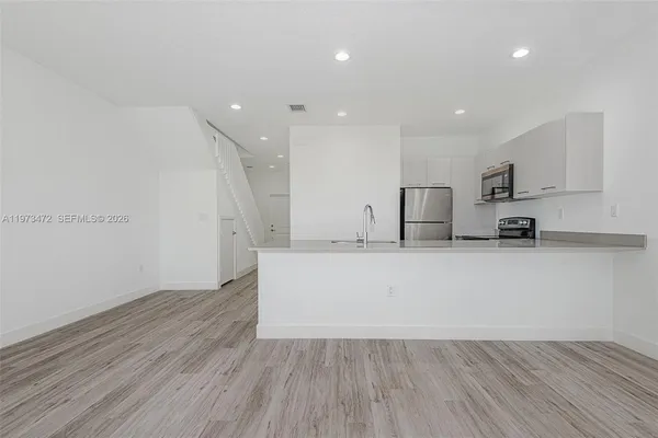 a view of kitchen with wooden floor and window