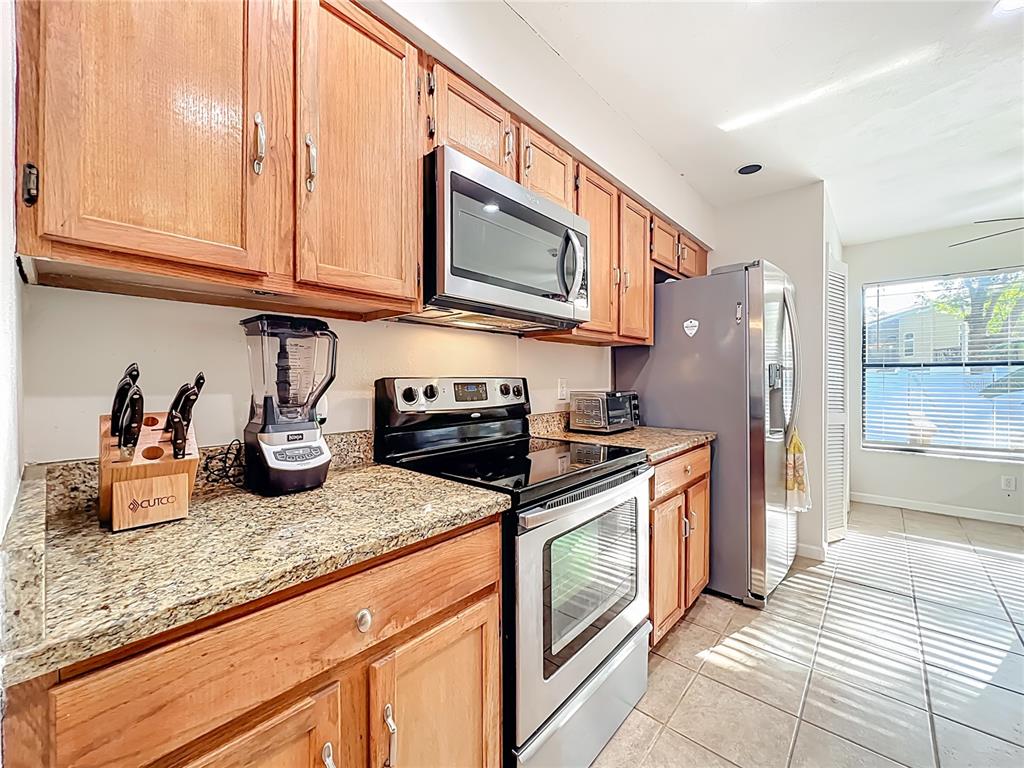 709 Lighthouse Court Altamonte Springs, FL 32714 - Photo 15 of 51 a kitchen with stainless steel appliances granite countertop a stove a sink and a microwave