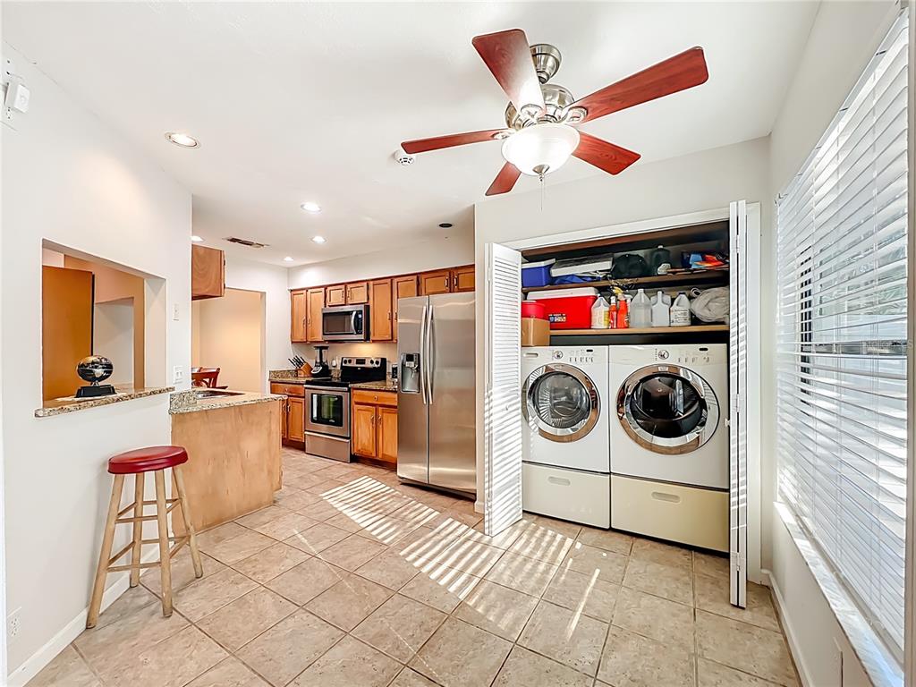 709 Lighthouse Court Altamonte Springs, FL 32714 - Photo 19 of 51 a kitchen with a stove a microwave and cabinets