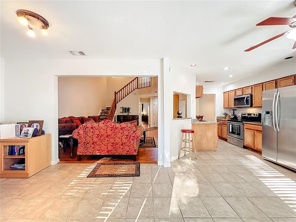 709 Lighthouse Court Altamonte Springs, FL 32714 - Photo 21 of 51 a living room with stainless steel appliances kitchen island granite countertop a refrigerator and cabinets