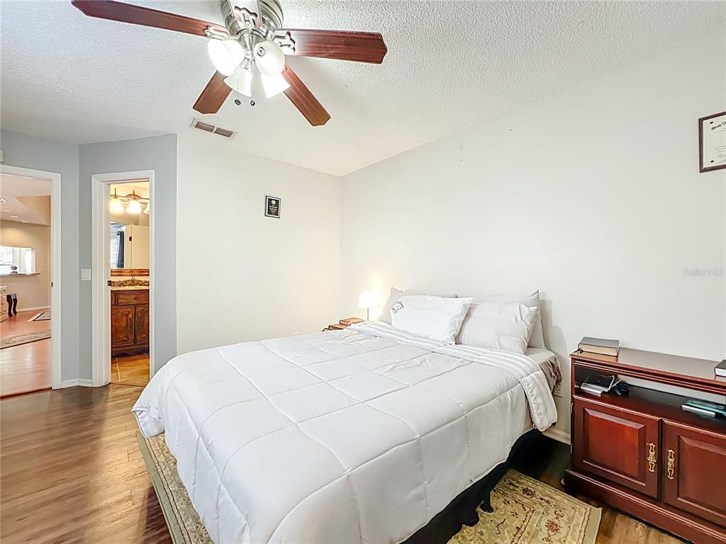 709 Lighthouse Court Altamonte Springs, FL 32714 - Photo 26 of 51 a bedroom with a bed and wooden floor