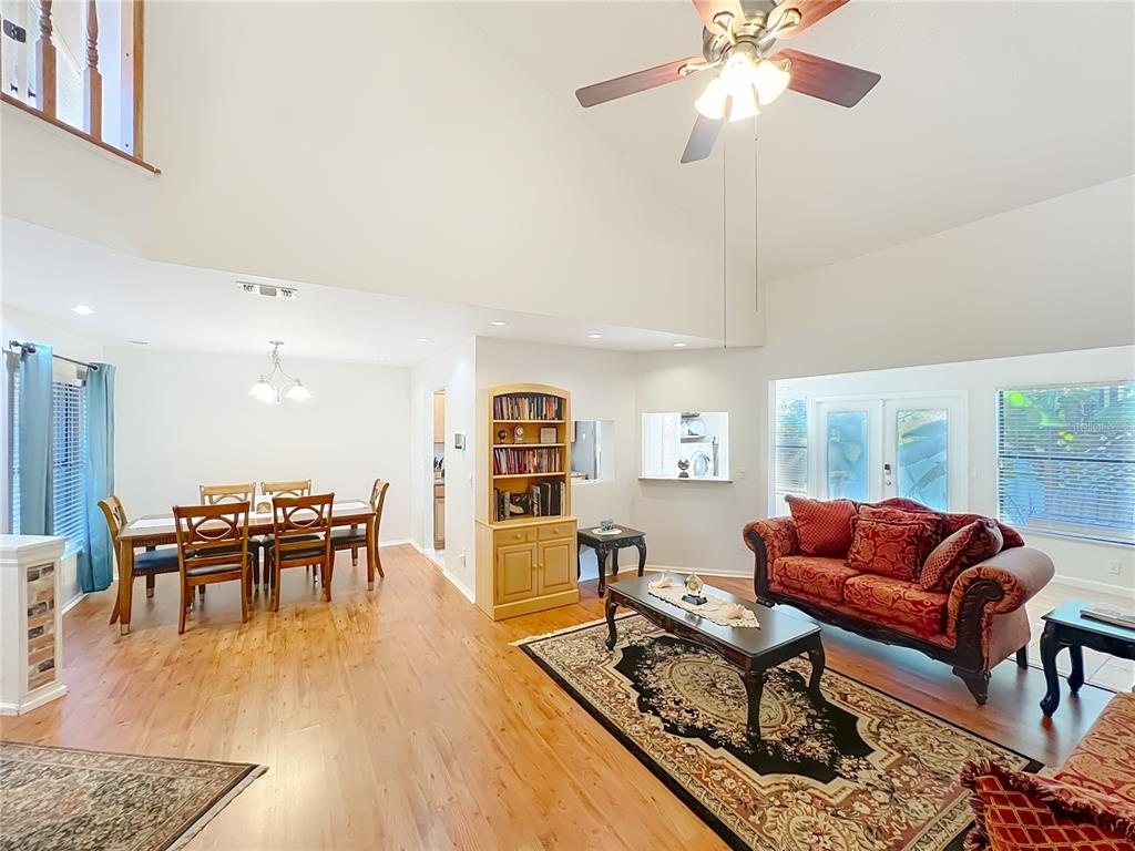 709 Lighthouse Court Altamonte Springs, FL 32714 - Photo 8 of 51 a living room with furniture a wooden floor and chandelier