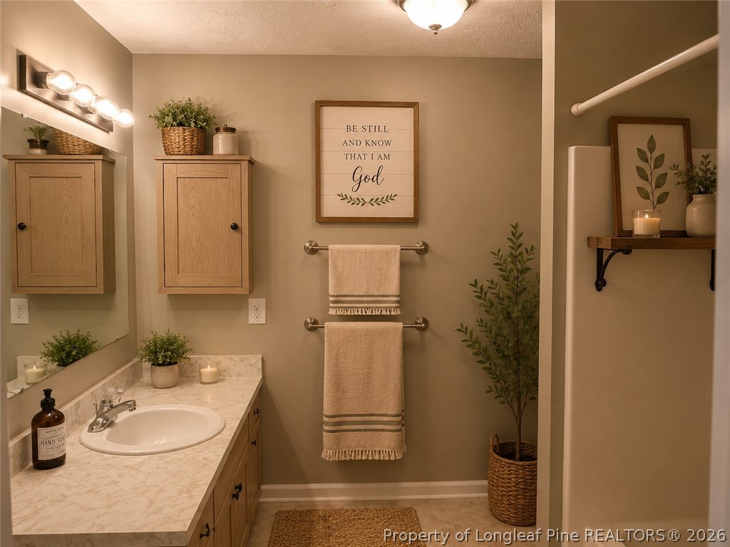 1833 Sardonyx Road, Unit 3 Fayetteville, NC 28303 - Photo 8 of 10 a bathroom with a sink a toilet and shower