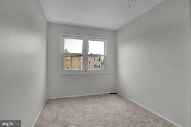an empty room with closet and a bathroom