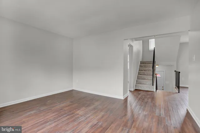 a view of an empty room and wooden floor