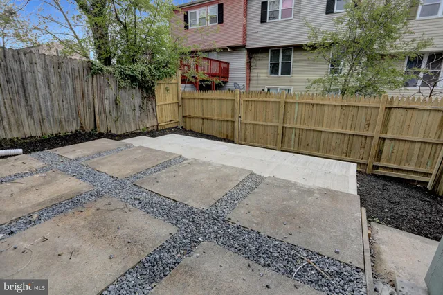 a view of a house with a wooden fence
