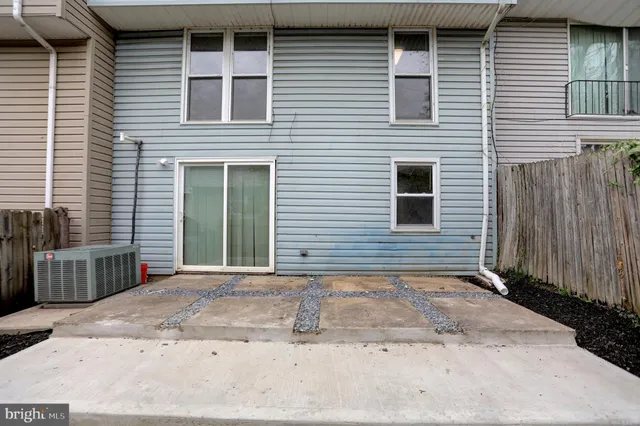 a view of a brick house with many windows and a yard