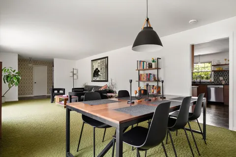 a view of a dining room with furniture and window