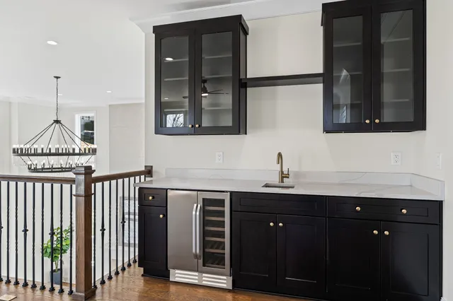 a view of a big room with wooden floor and windows