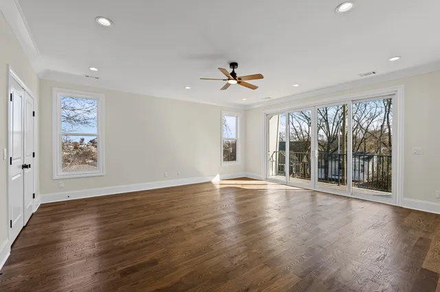 a view of an empty room with wooden floor