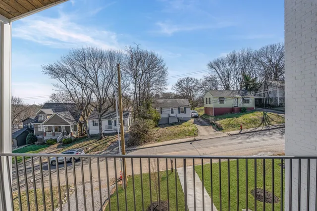an empty room with wooden floor and ceiling fan