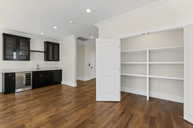 a view of a room with wooden floor and windows