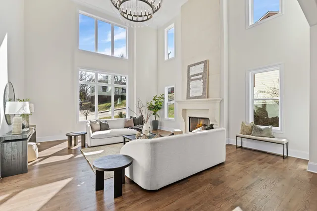 a kitchen with stainless steel appliances kitchen island granite countertop a stove a sink a dining table and chairs