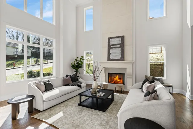 a kitchen with stainless steel appliances a stove a sink a refrigerator and chairs