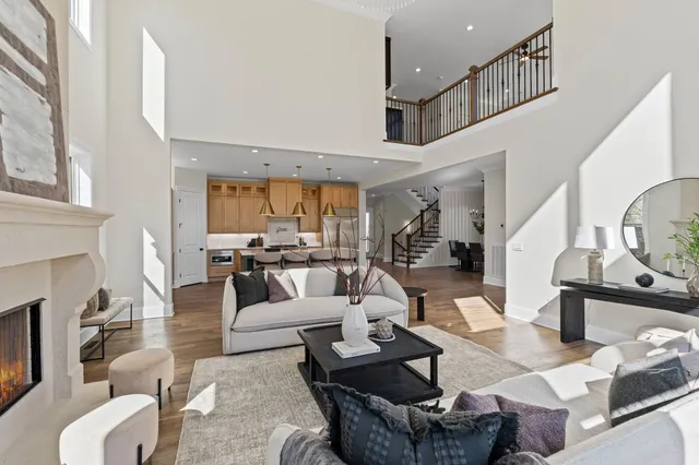 a kitchen with sink a stove and chairs with wooden floor