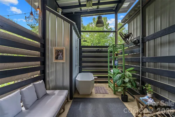 a view of a porch with furniture and a potted plant