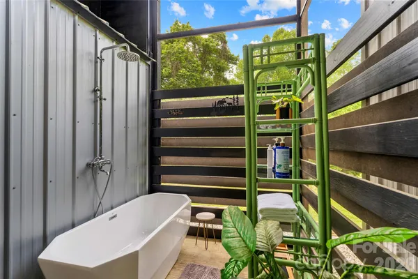 a bathroom with a bathtub and a shower