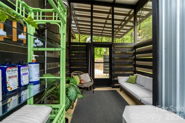 a view of a porch with furniture and a yard