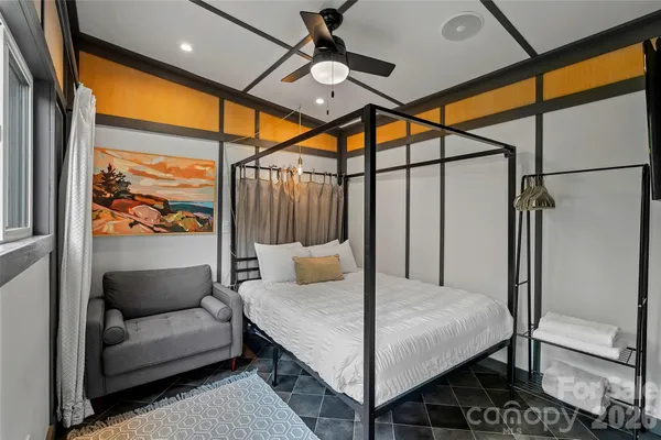 a bedroom with a bed and glass window