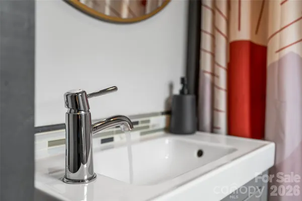 a bathroom with a sink a vanity and a mirror