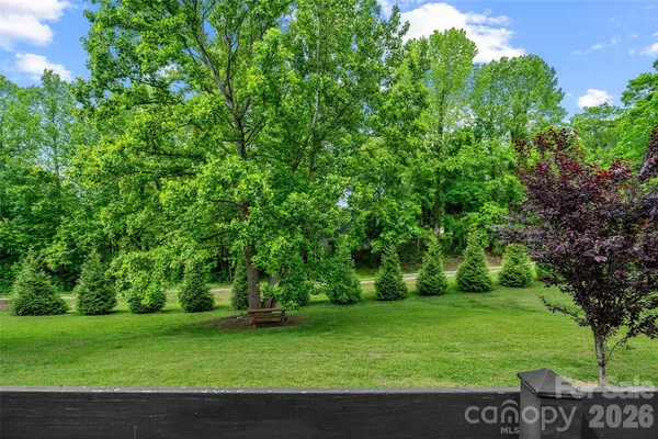 a view of a small house with a tree in the background