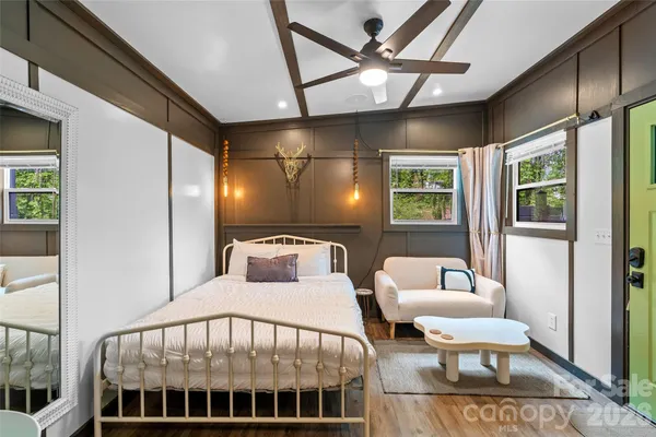 a bedroom with a bed a couch and dresser