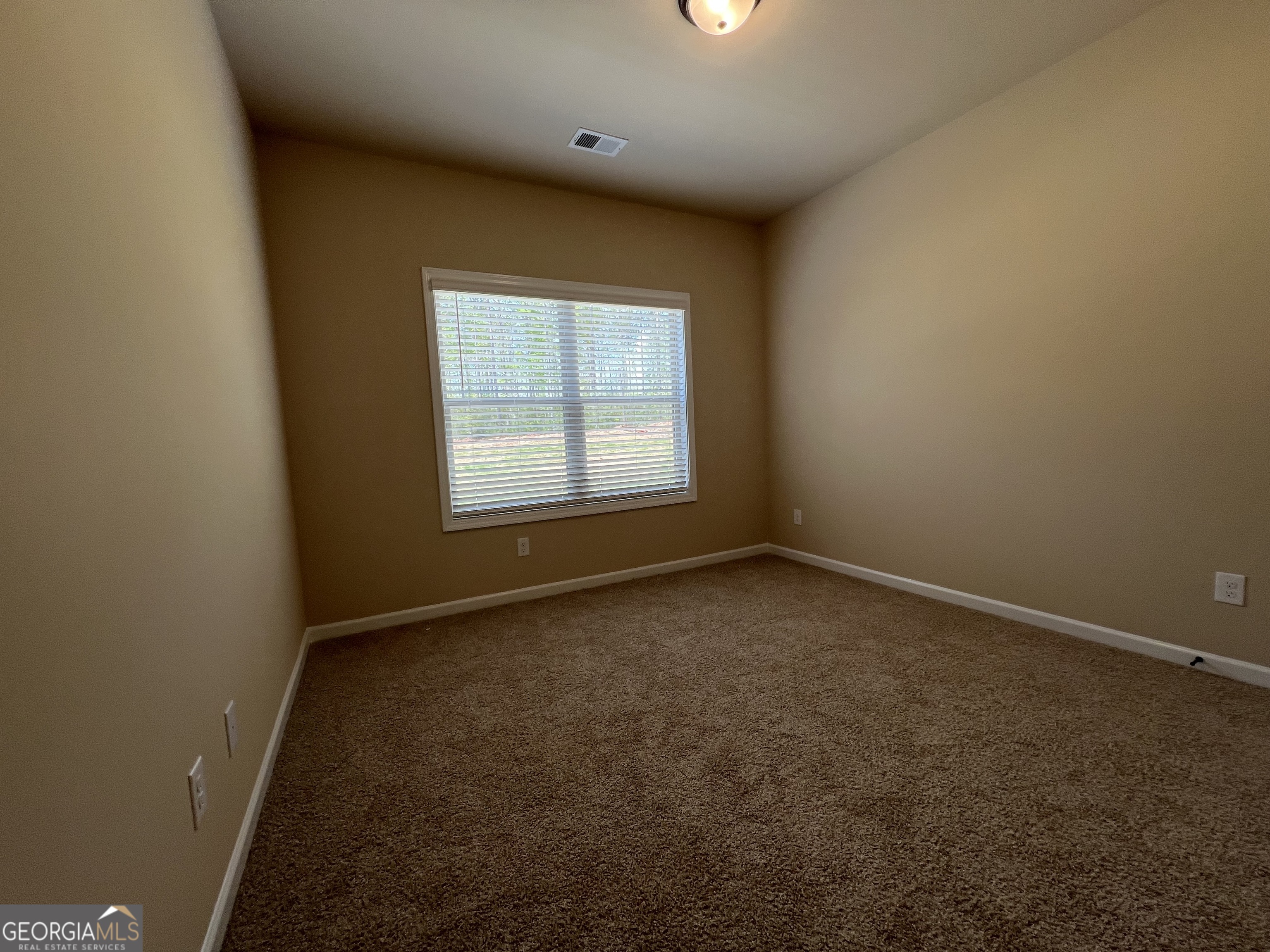 341 Homestead Circle Forsyth, GA 31029 - Photo 16 of 38 an empty room with a empty space and windows