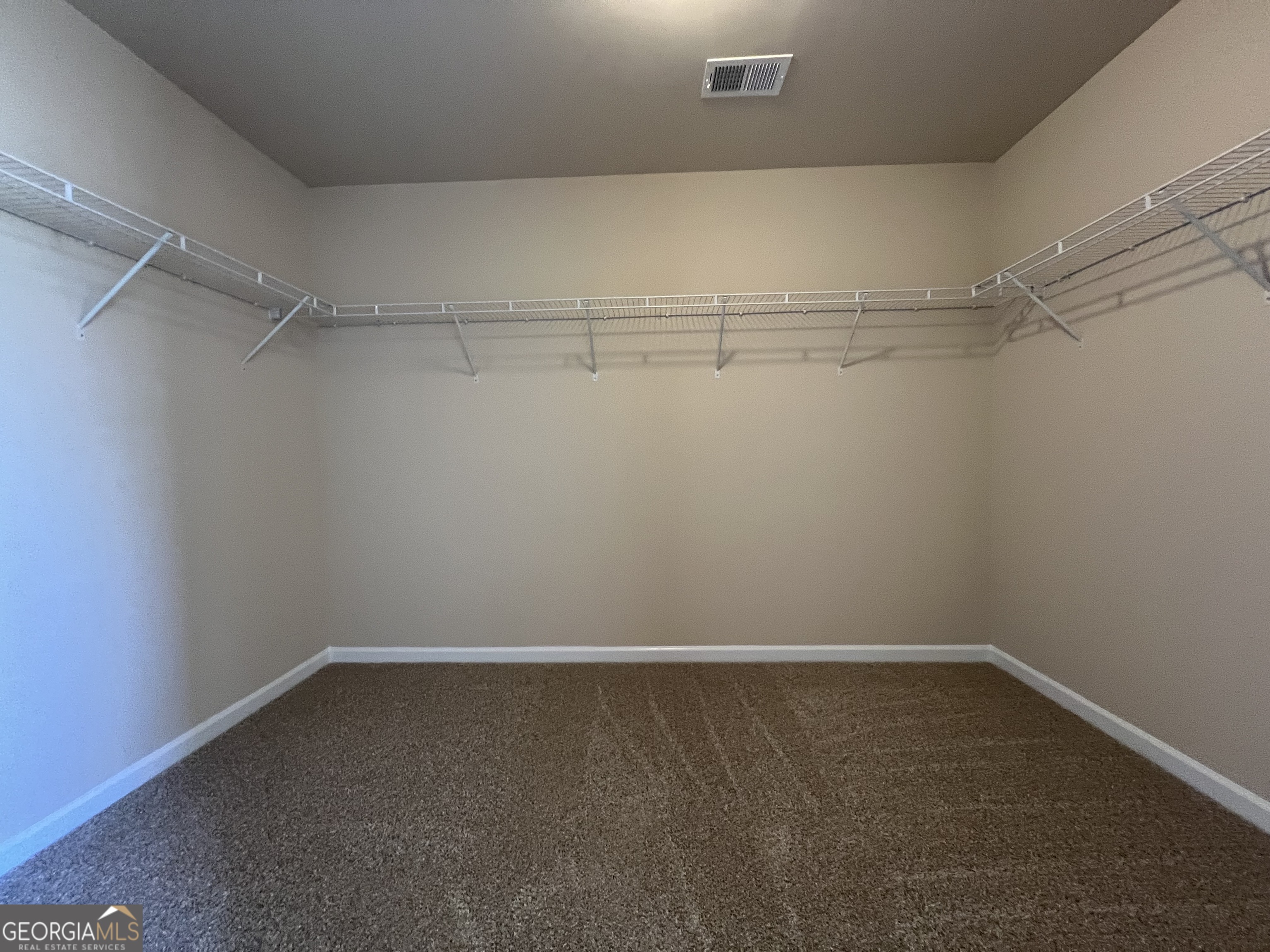 341 Homestead Circle Forsyth, GA 31029 - Photo 19 of 38 a view of a room with racks on the wall