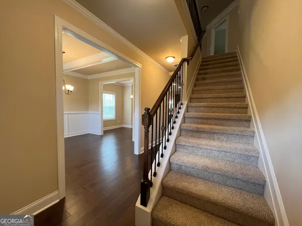 a view of entryway and hall with wooden floor