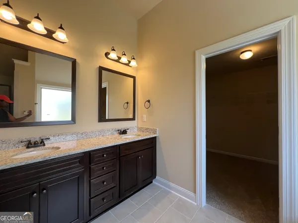 a bathroom with a double vanity sink and mirror