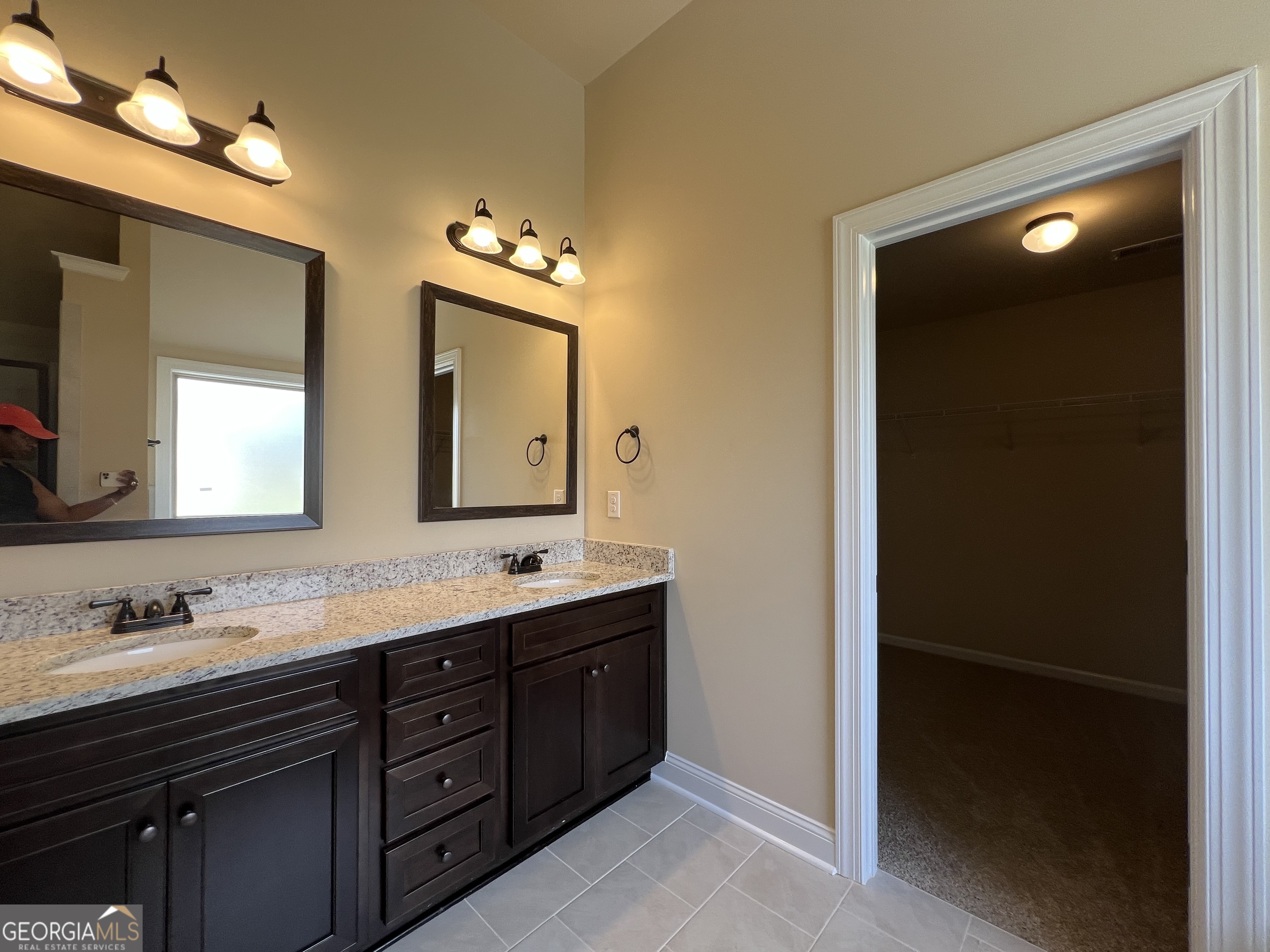 341 Homestead Circle Forsyth, GA 31029 - Photo 22 of 38 a bathroom with a double vanity sink and mirror