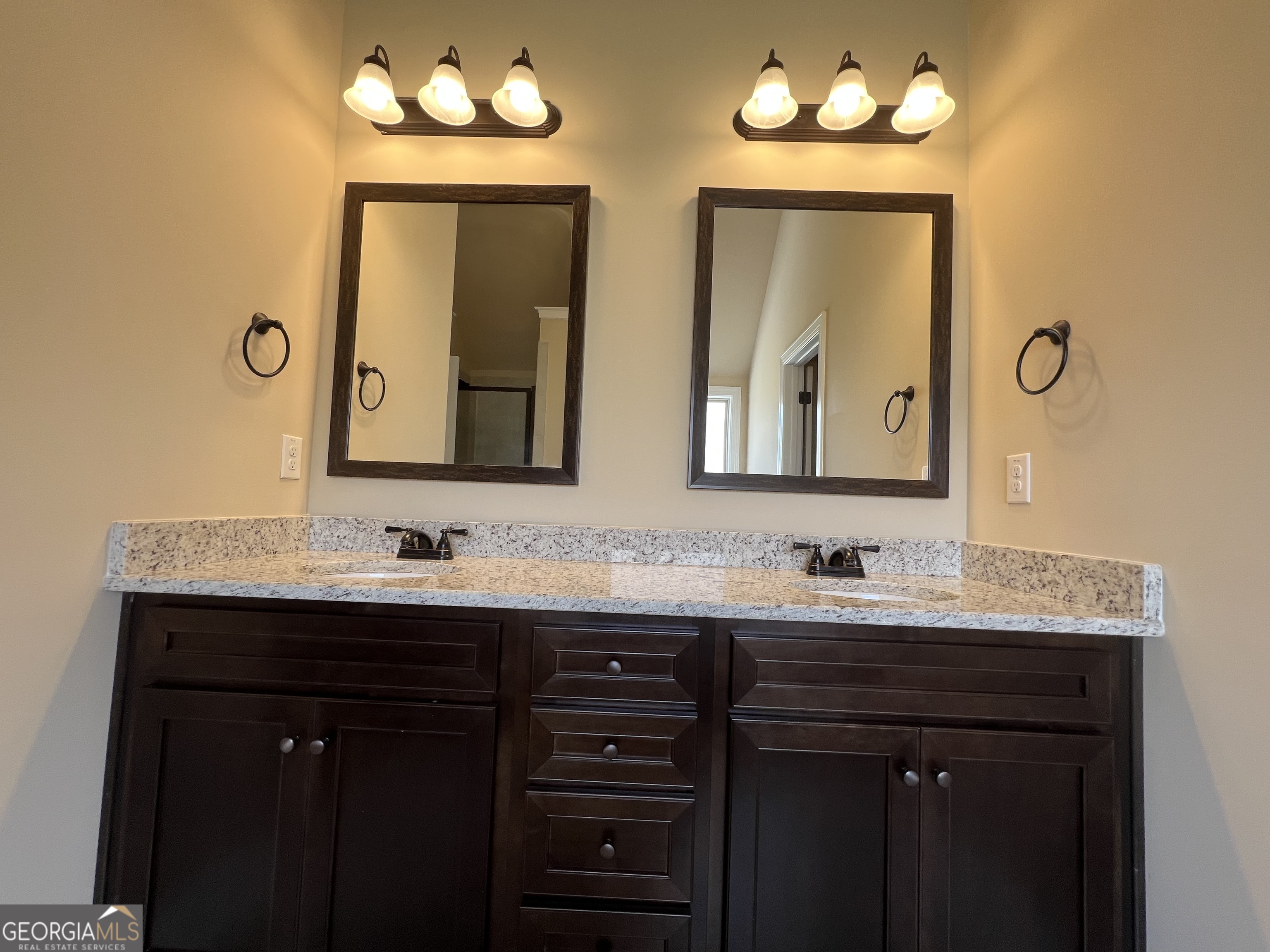 341 Homestead Circle Forsyth, GA 31029 - Photo 24 of 38 a bathroom with double vanity sinks and a mirror