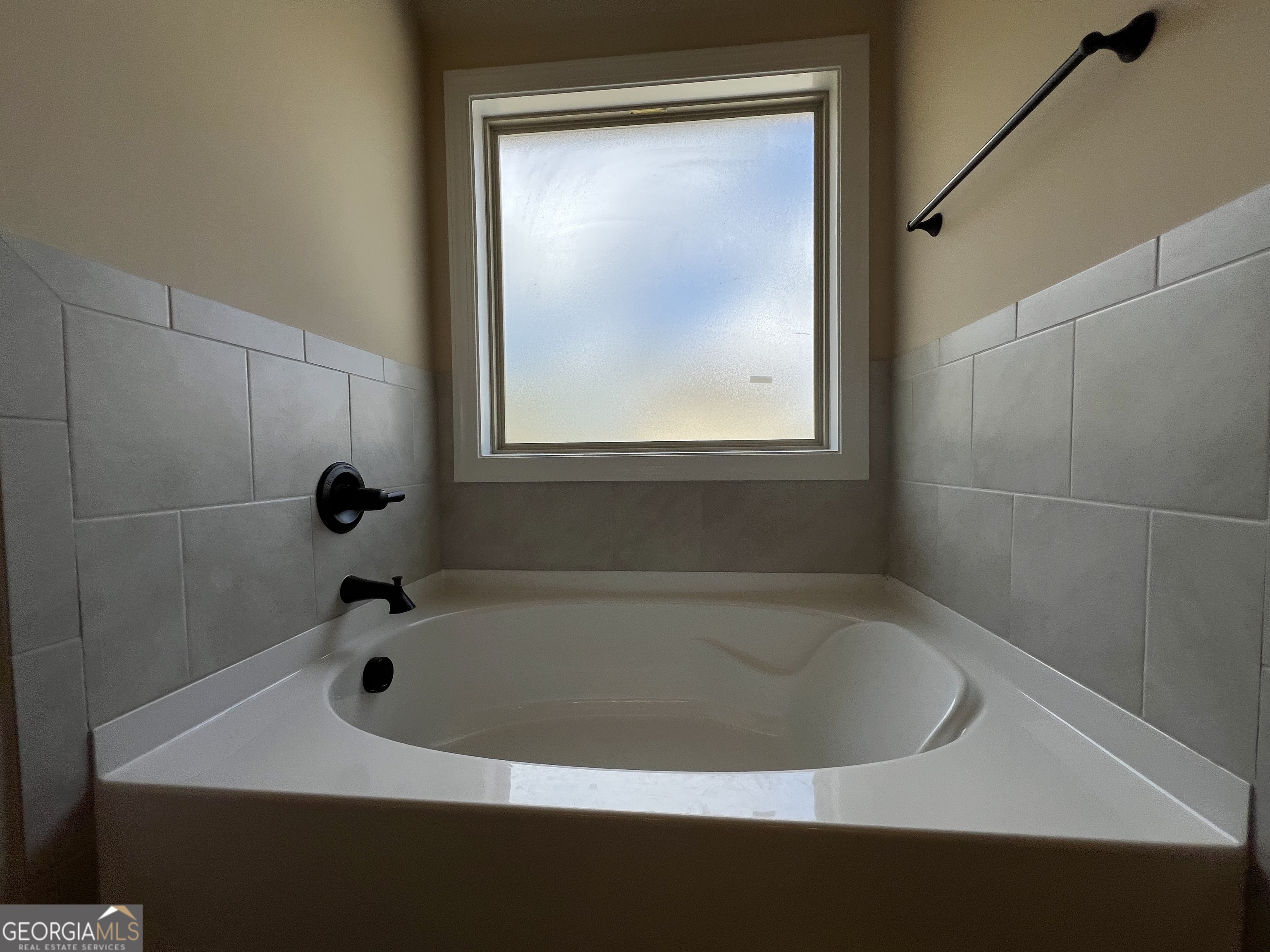 341 Homestead Circle Forsyth, GA 31029 - Photo 25 of 38 a bathroom with a bathtub