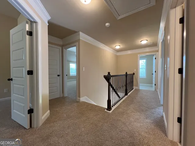 wooden view of a hallway with closet