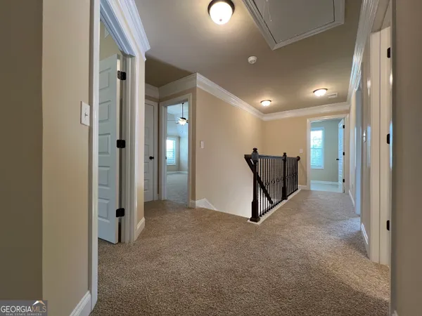 a view of a hallway with some furniture and stairs