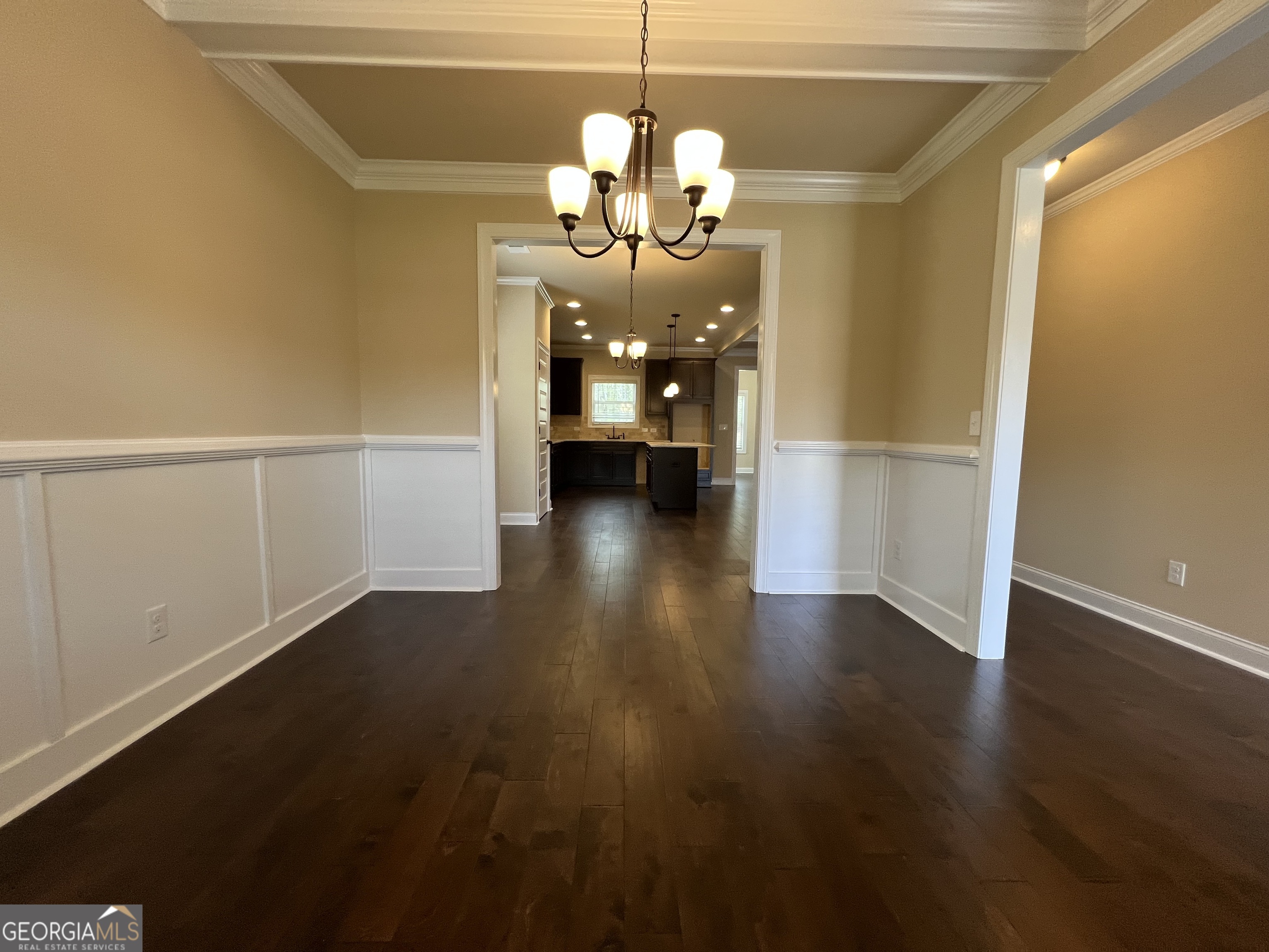 341 Homestead Circle Forsyth, GA 31029 - Photo 5 of 38 a hallway with wooden floor chandelier and livingroom view