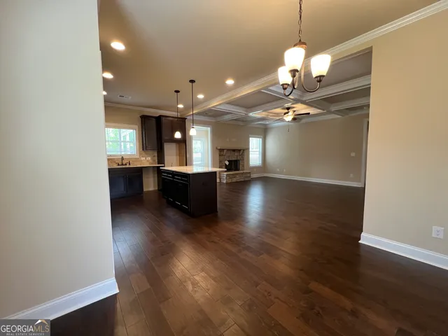 a view of a kitchen with sink and wooden floor