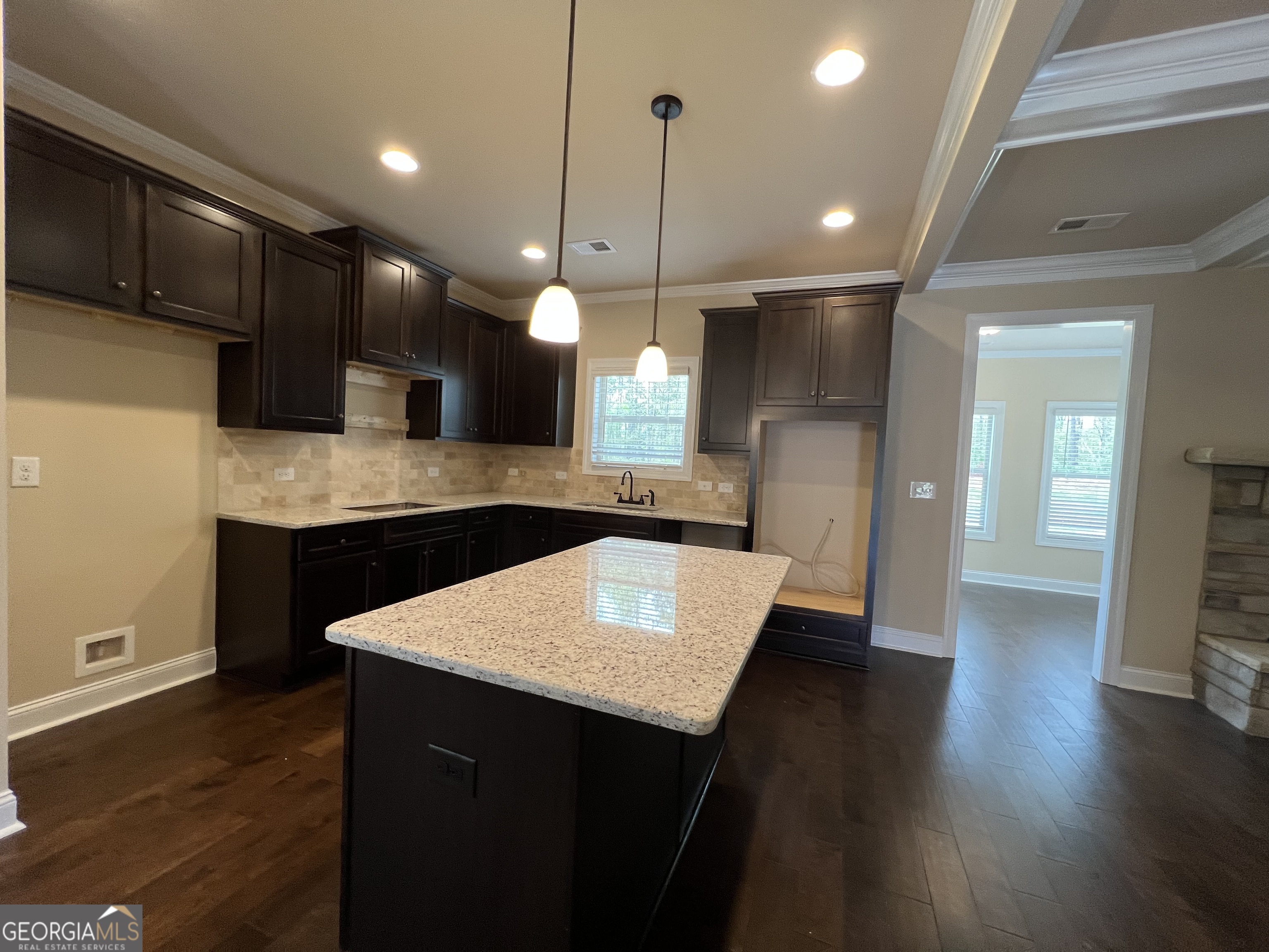341 Homestead Circle Forsyth, GA 31029 - Photo 9 of 38 a large kitchen with stainless steel appliances kitchen island a refrigerator and a sink