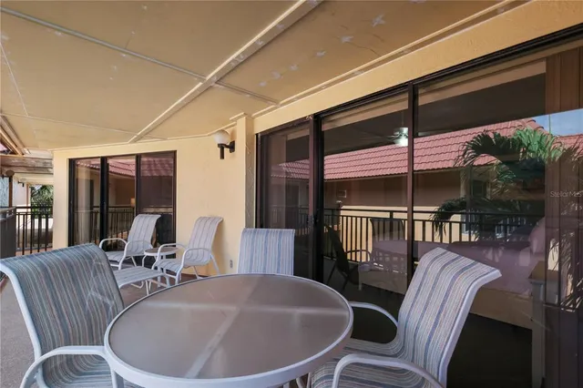 a kitchen with granite countertop white cabinets and stainless steel appliances