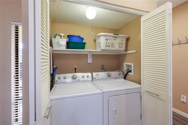 a view of a patio with a table and chairs and potted plants