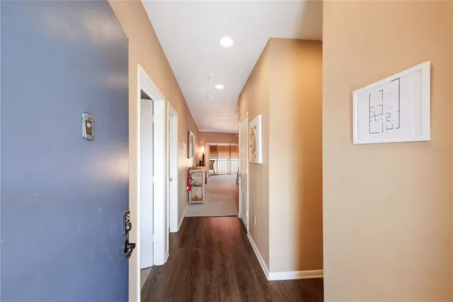 a view of a hallway with wooden floor