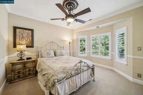 a spacious bathroom with a granite countertop double vanity sink a mirror and a shower