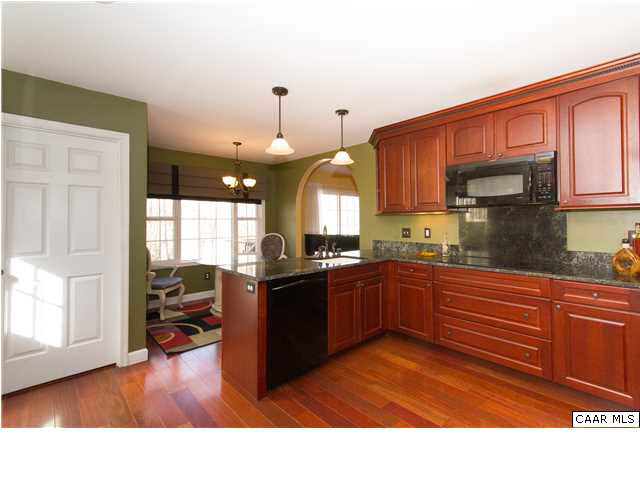 66 Amethyst Road Palmyra, VA 22963 - Photo 4 of 30 a kitchen with stainless steel appliances granite countertop a refrigerator a sink dishwasher a stove and a dining table with wooden floor