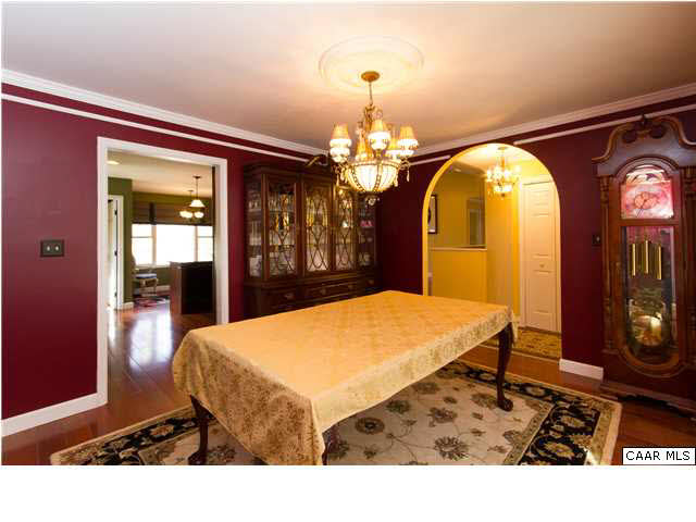 66 Amethyst Road Palmyra, VA 22963 - Photo 8 of 30 a living room with a table a chandelier and couches with wooden floor