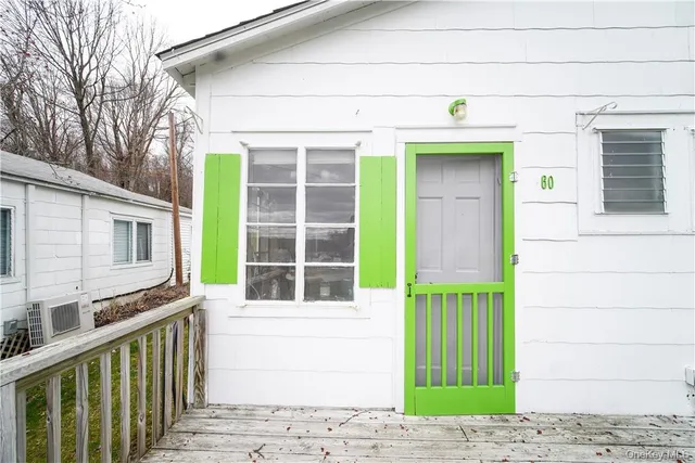 a view of a house with a window and wooden fence