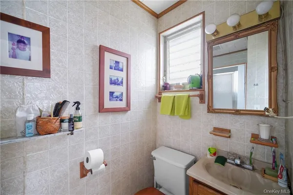 a bathroom with a toilet sink and mirror