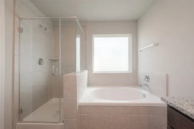 a white bath tub sitting next to a shower